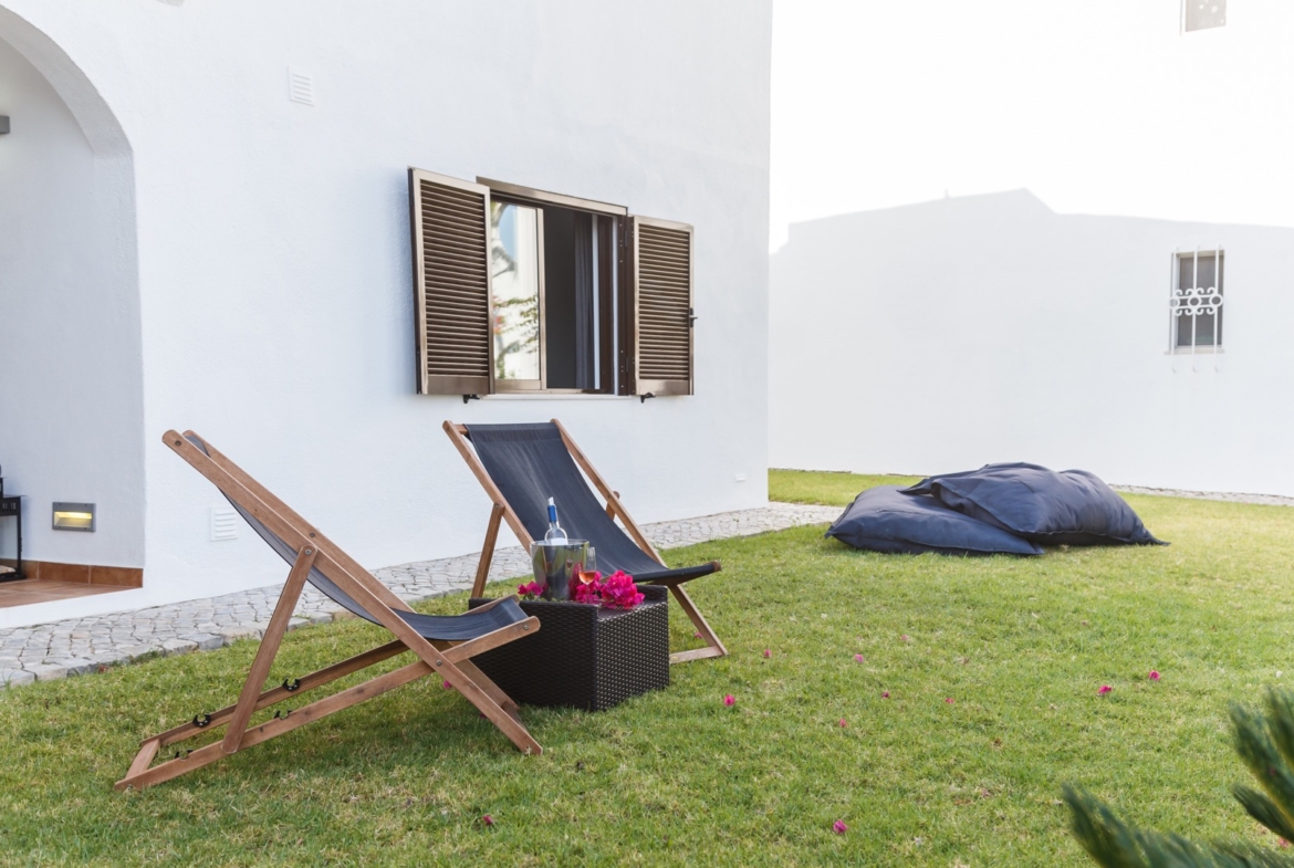 summer apartment garden with chairs and pillows setup
